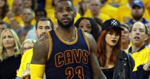 LeBron James at an NBA game with Rihanna behind him