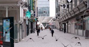 Streets of Belgium with few people and lots of birds