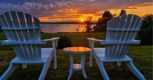 adirondack chairs on chebeague island, maine, at sunset