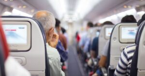 crowded-plane-aisle-passengers