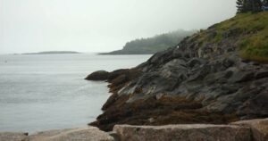 a cliffside view from mohegan island, maine