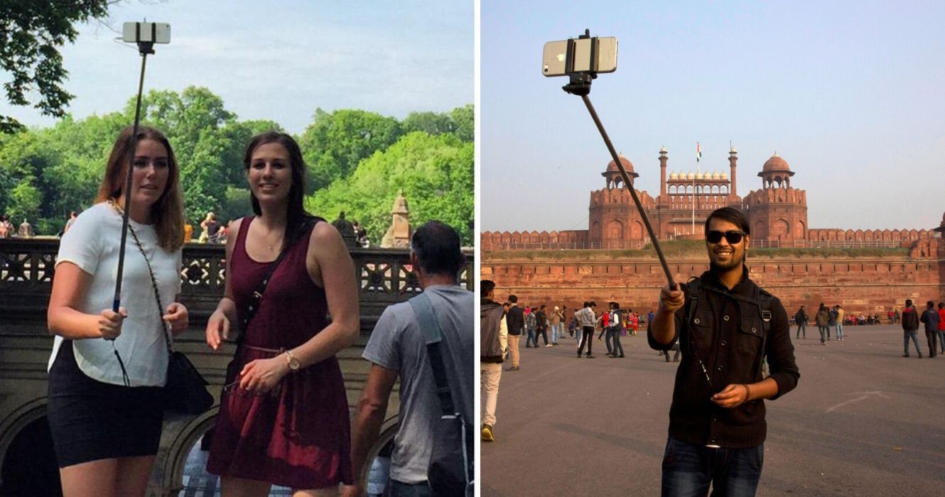 amigos tentam tirar uma selfie com um bastão de selfie, um cara tira uma selfie em um marco nacional
