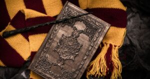 harry potter scarf, spellbook, and wand