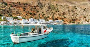 a boat docked in the harbor on the island of crete in greece