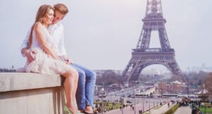 affectionate couple sitting near Eiffel Tower in Paris