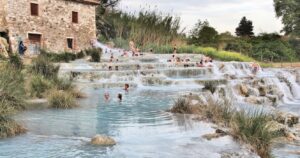 people in saturnia hot spring in tuscany, italy